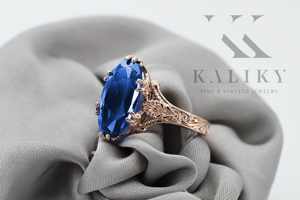 Vintage Sapphire Ring in 14K Rose Gold (vrc084r-sp) — worn on the neckline, showing the drape