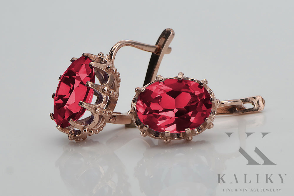 Vintage Ruby Lady Earrings in 14K Rose Gold (vec079r-rb) — worn on the neckline, showing the drape