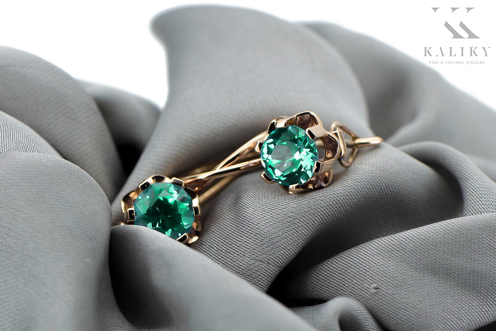 Vintage Emerald Earrings in 14K Rose Gold (vec019r-em) — worn on the neckline, showing the drape