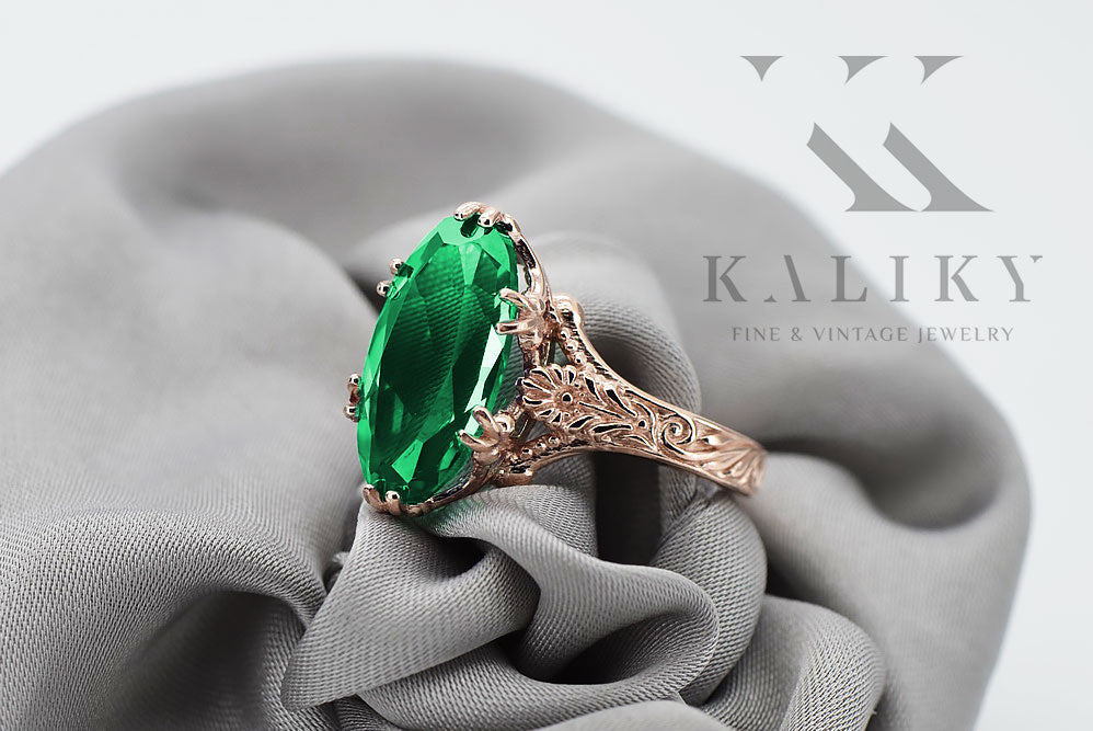Vintage Emerald Oval Ring in 14K Rose Gold (vrc084r-em) — worn on the neckline, showing the drape