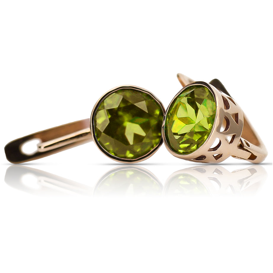 Vintage yellow peridot earrings in 14K rose gold, round bezel-set stones and openwork baskets on white background