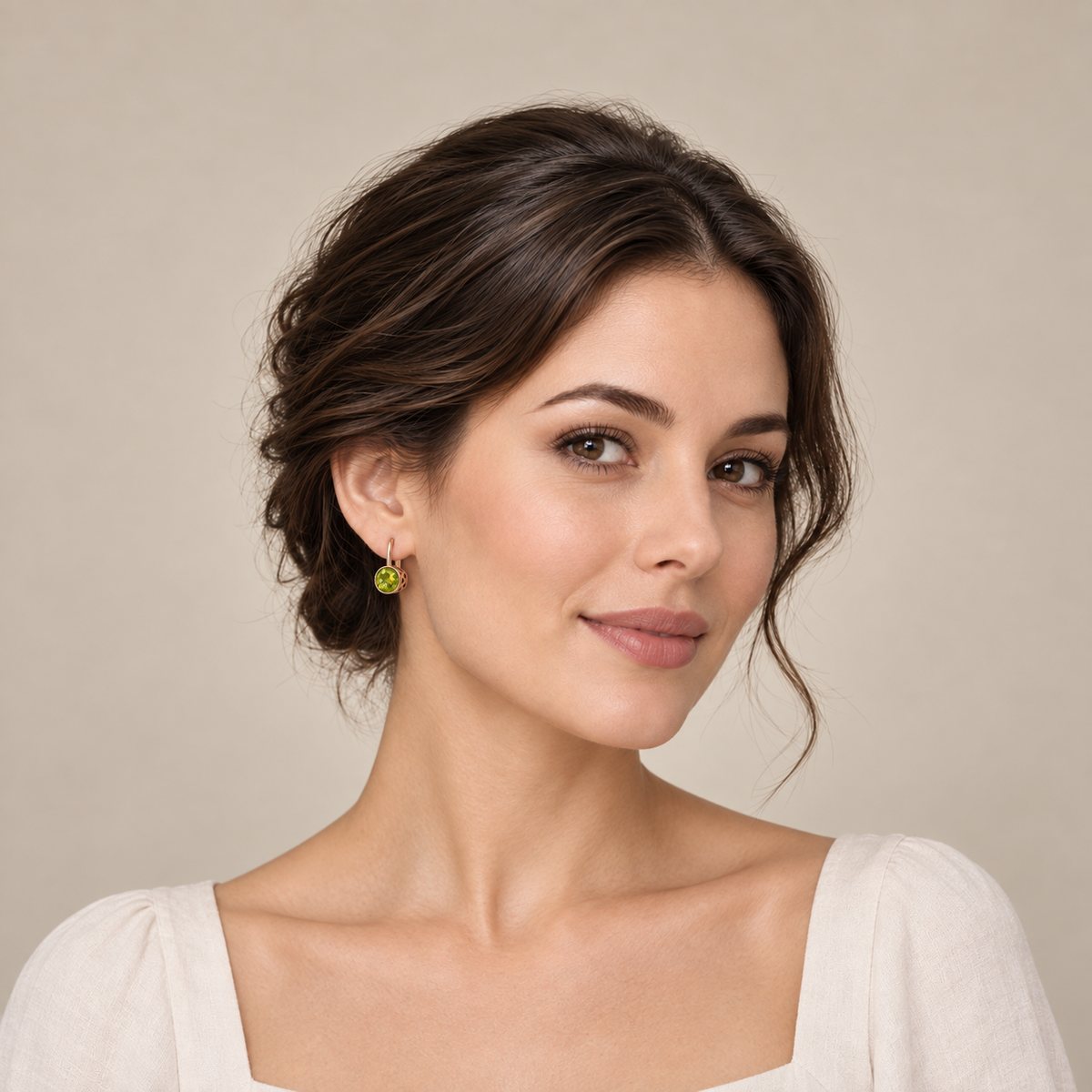 Model wearing a round yellow-green peridot earring in 14K rose gold, full head portrait