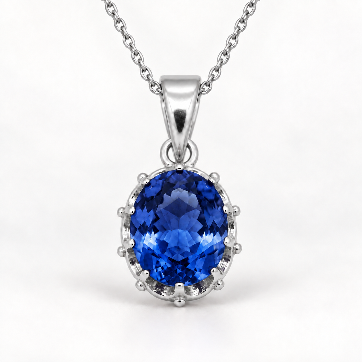 Oval sapphire pendant in sterling silver on white background